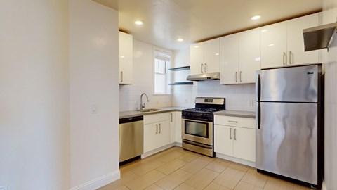 A kitchen with white cabinets and stainless steel appliances.