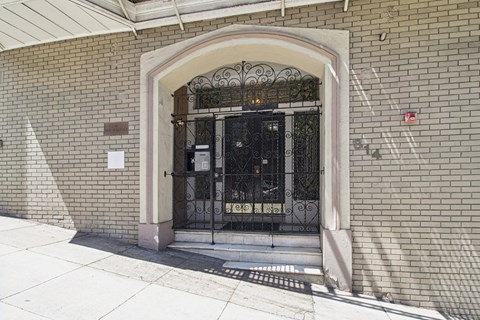 A building with a brick wall and a metal gate.