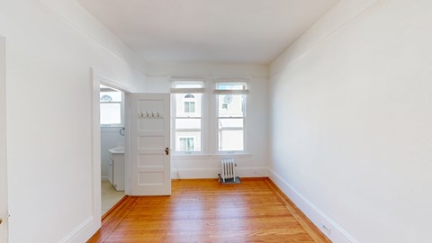 A room with wooden floors and white walls.