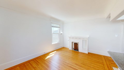 A room with a fireplace and a window.