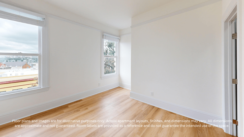 A room with a window overlooking a cityscape.