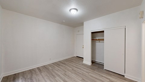 A room with a white door and a light on the ceiling.