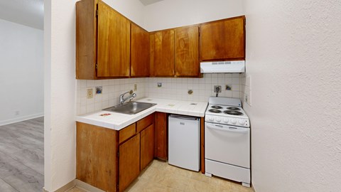A kitchen with wooden cabinets and white appliances.