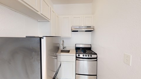 A small kitchen with a stove and a refrigerator.