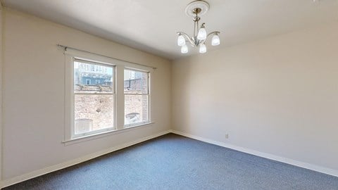 A room with a window overlooking a construction site.