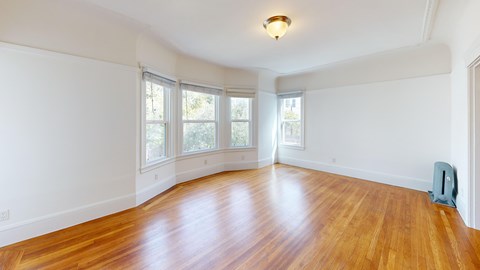 A room with wooden floors and white walls.