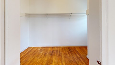 A room with wooden floors and white walls.