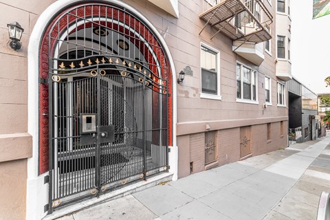 A large black gate with a red arch above it.