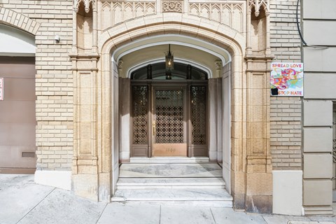 A building entrance with a sign that says "Spread Love".