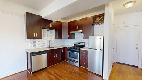 A kitchen with wooden cabinets and stainless steel appliances.
