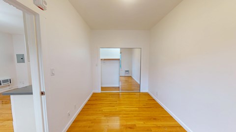 A room with wooden floors and white walls.