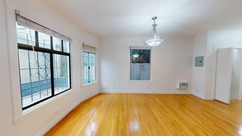 A room with wooden floors and white walls.