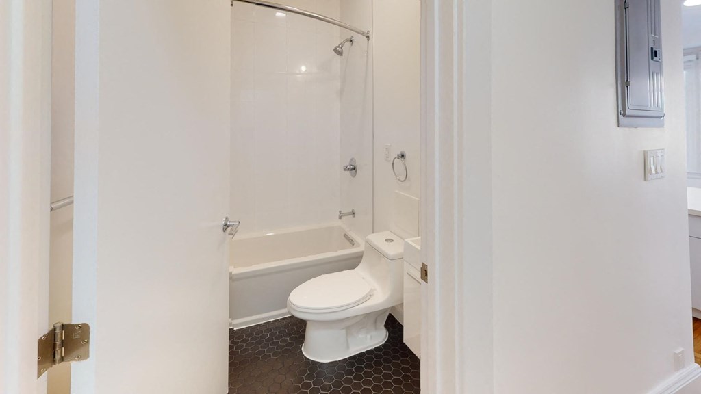 a bathroom with a toilet and a shower