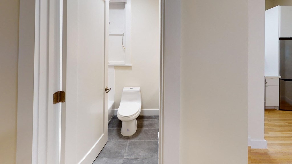a small bathroom with a toilet and a cabinet
