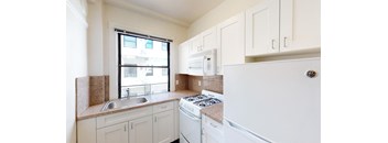 a kitchen with white appliances and white cabinets