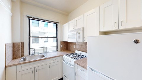a kitchen with white appliances and white cabinets