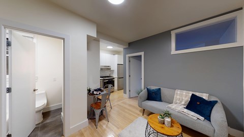 A living room with a grey couch and a coffee table.