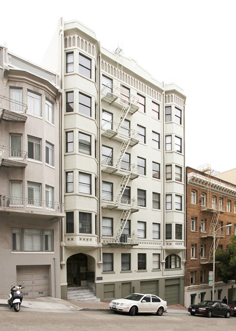 a building with a fire escape on the side of a street