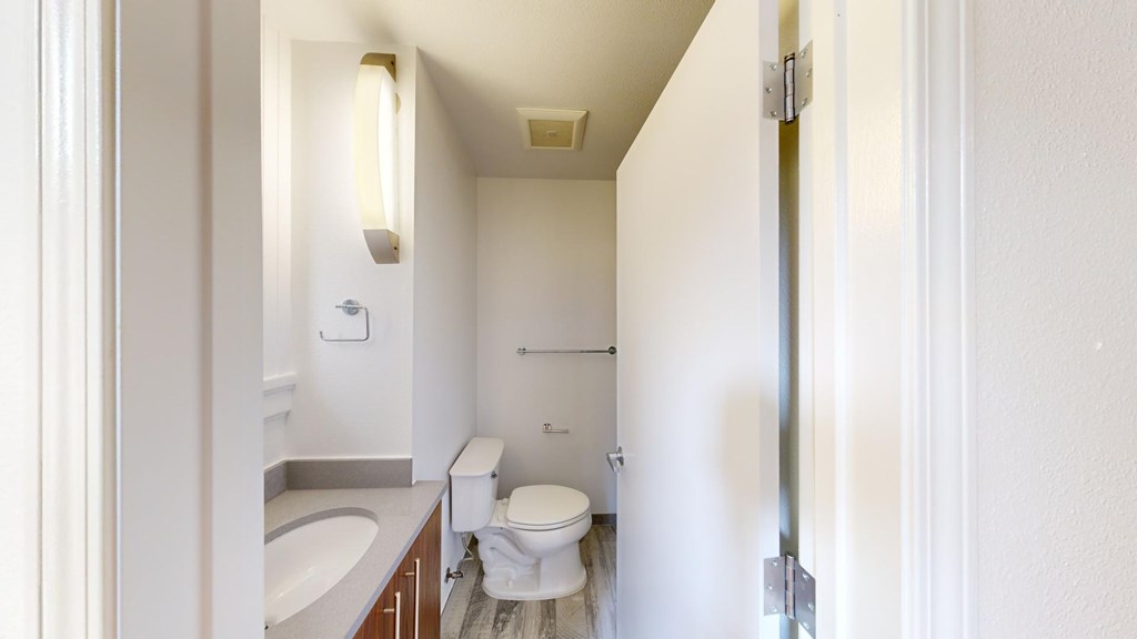 A white bathroom with a toilet, sink, and bathtub.