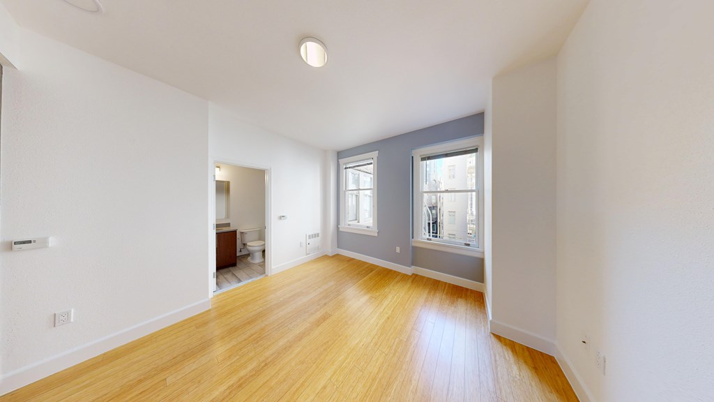 A room with wooden floors and white walls.
