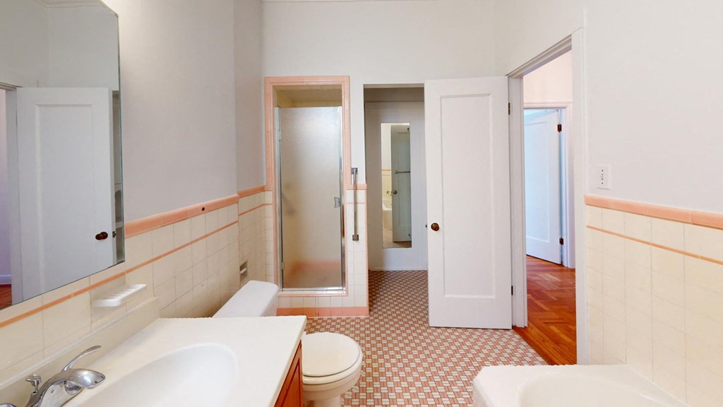 a bathroom with a toilet sink and a mirror