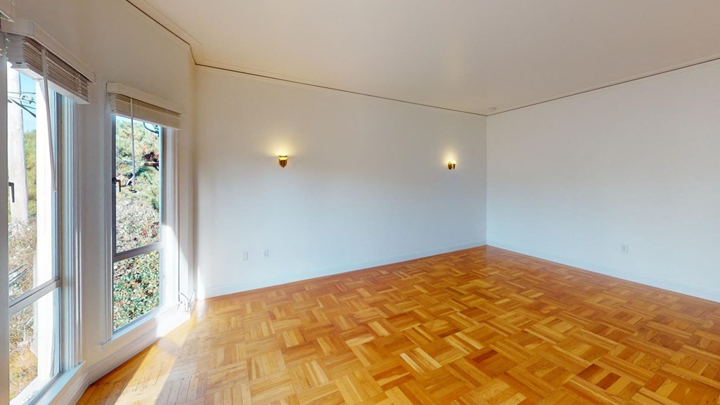 a living room with wood flooring and a window