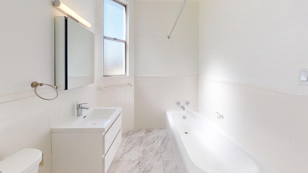 Bathroom with a toilet, sink and bathtub Bathroom with a toilet, sink and bathtub
