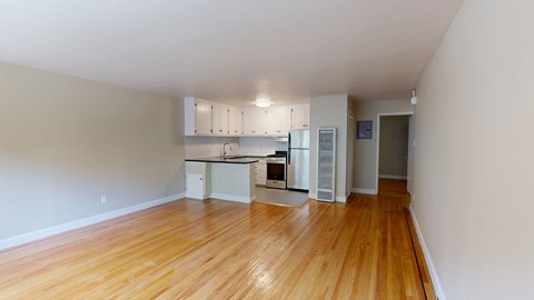 A kitchen with white cabinets and a black countertop.