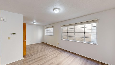 A room with a window and a door.
