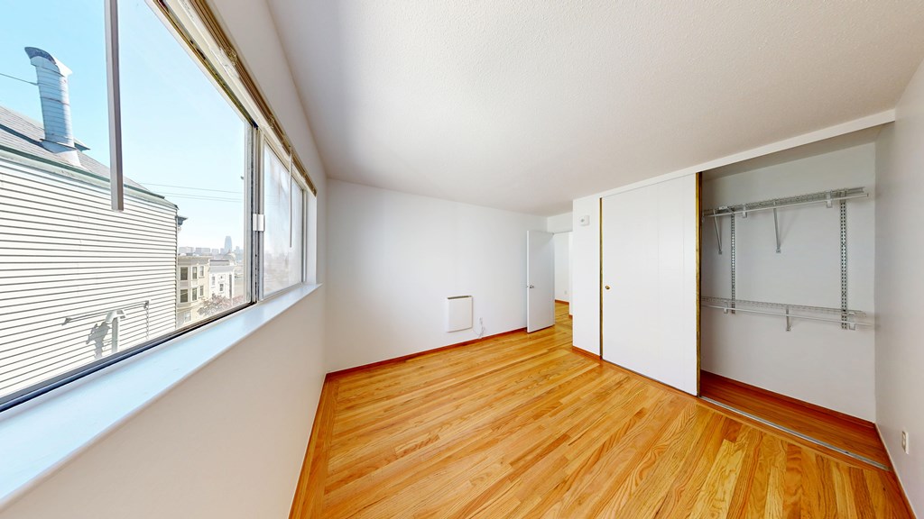 A room with wooden floors and white walls.