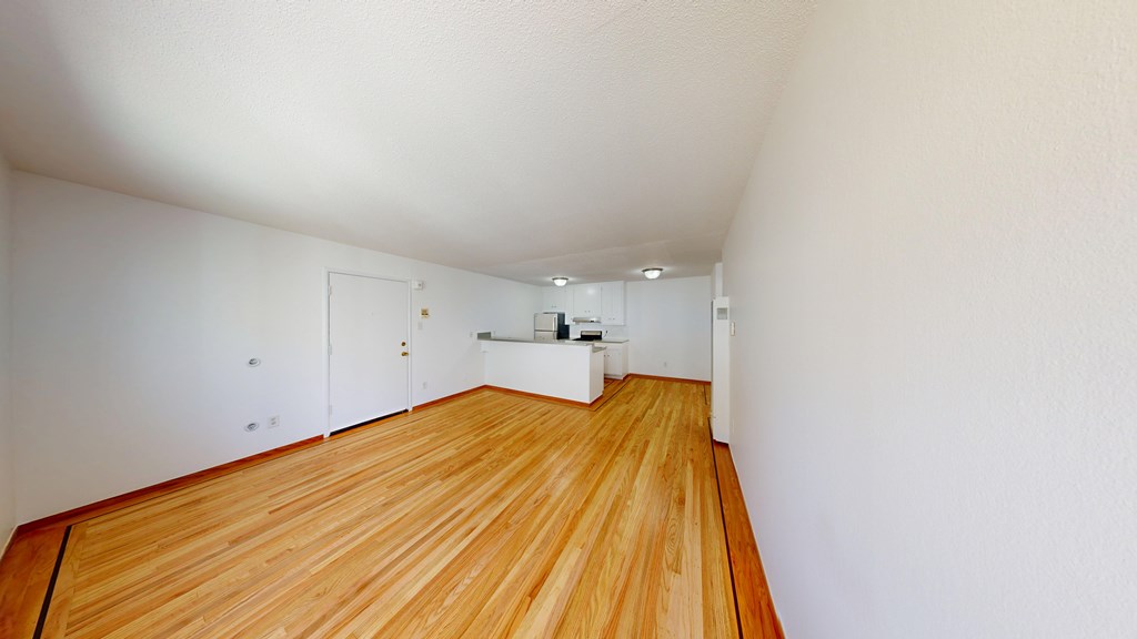 A room with wooden floors and white walls.