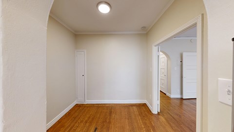 A room with wooden floors and white walls.