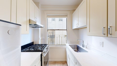 A kitchen with white appliances and cabinets.