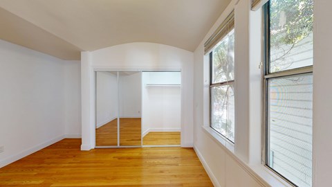 A room with wooden floors and white walls.