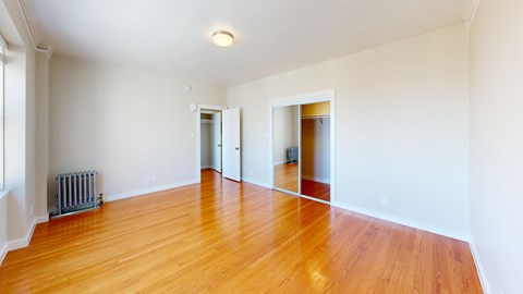 A room with wooden floors and white walls.