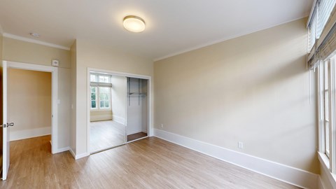 A room with a window and a door.