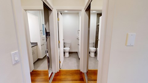 A white bathroom with a toilet and sink.