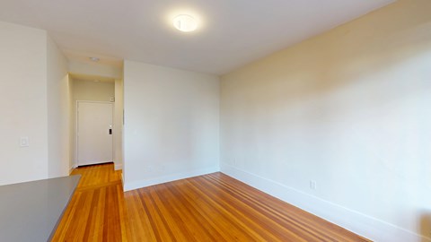 A room with wooden floors and a white door.