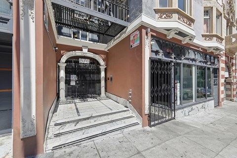 A building with a brown facade and a black gate.