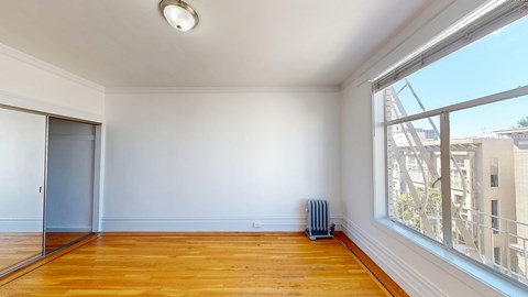 A room with wooden floors and a sliding glass door.