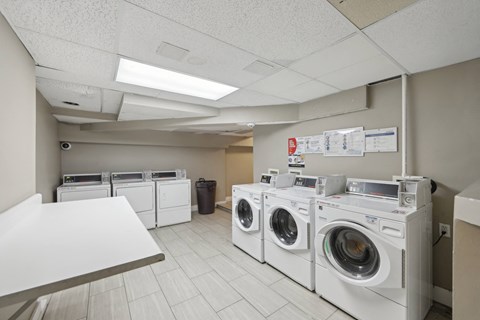 Apartment with a common area laundry with multiple washers and dryers