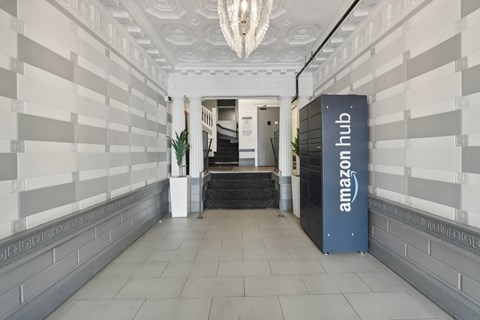 A hallway with a blue Amazon hub sign on the right.