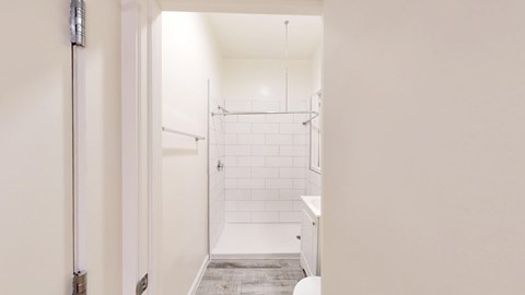 A white bathroom with a walk-in shower.