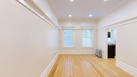 A room with wooden floors and white walls.