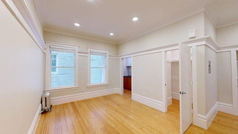 A room with wooden floors and white walls.