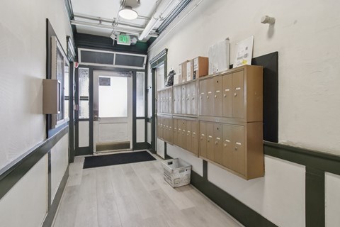 A long hallway with a black exit sign on the ceiling.