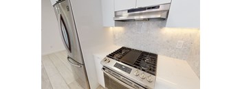 a kitchen with a stove and a refrigerator