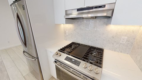 a kitchen with a stove and a refrigerator