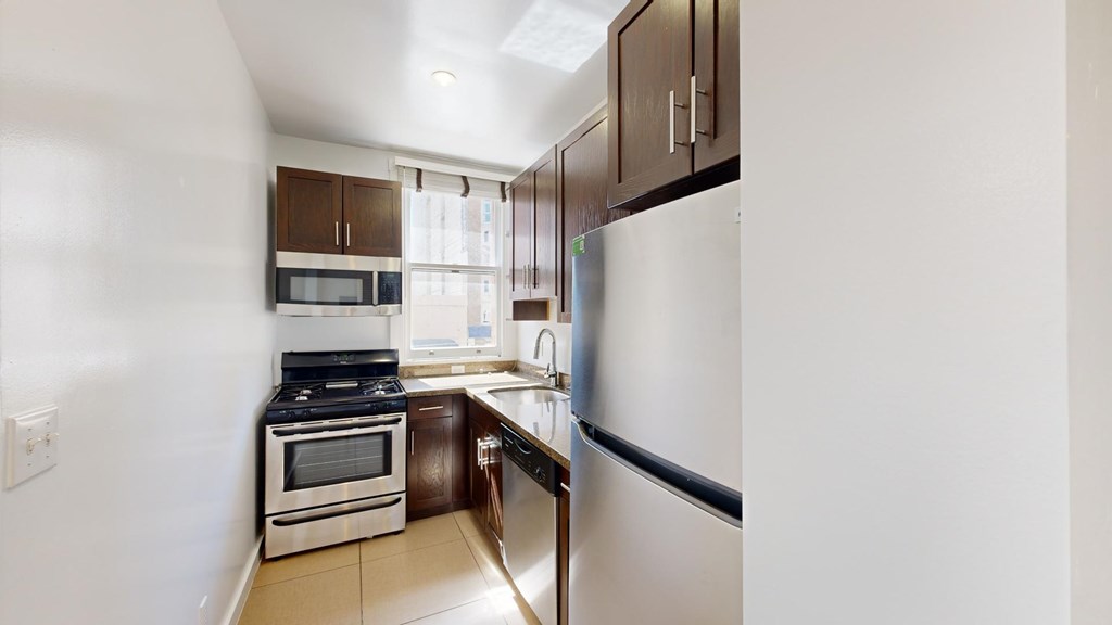 A kitchen with a stove, oven, and refrigerator.