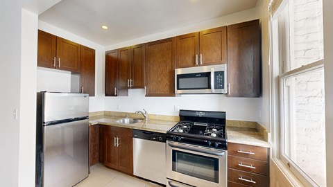 A kitchen with wooden cabinets and stainless steel appliances.
